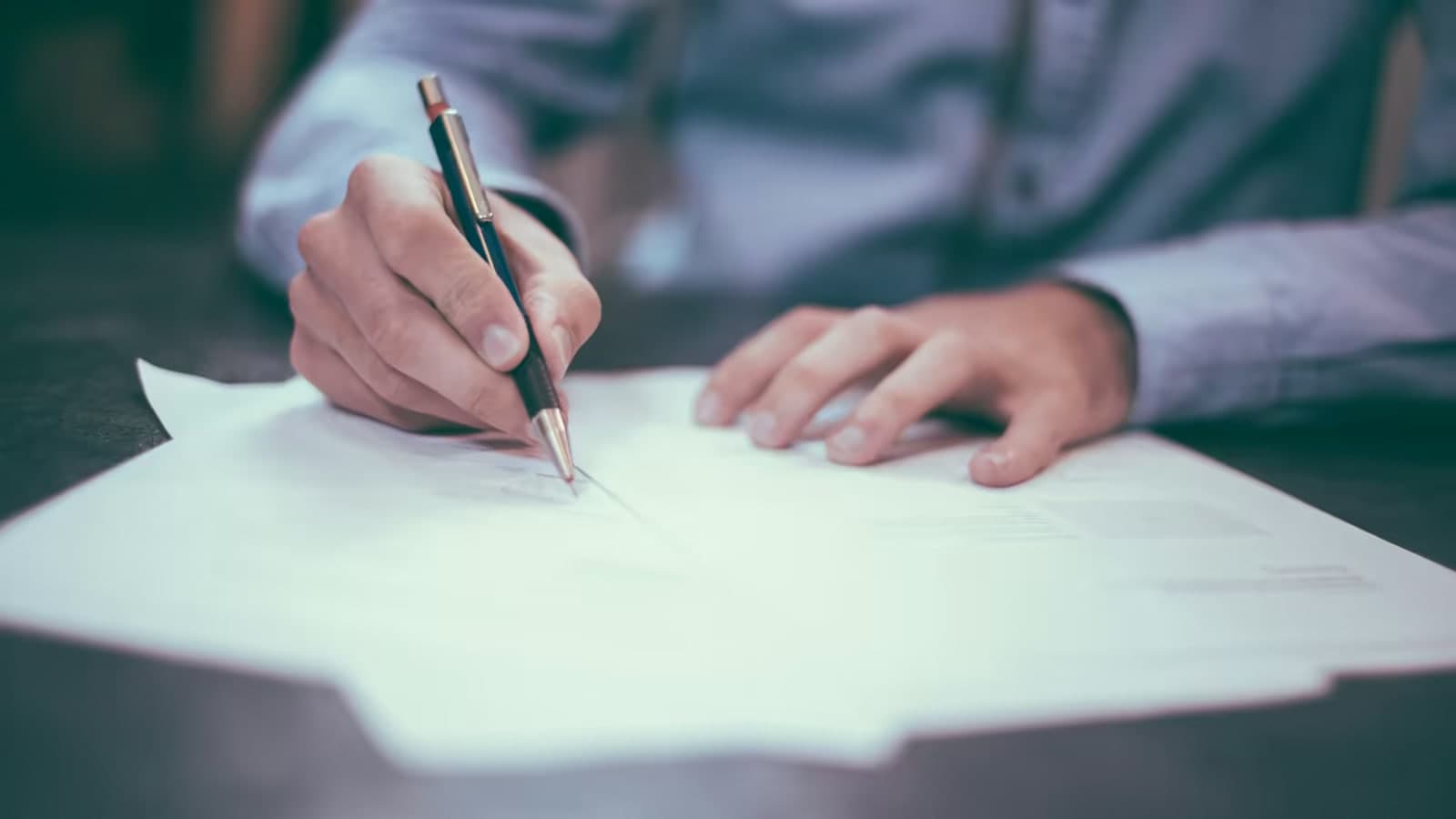 Close-up of hands marking up a document with a pen - working through the asset protection trust case record decision by decision, Blake Harris Law