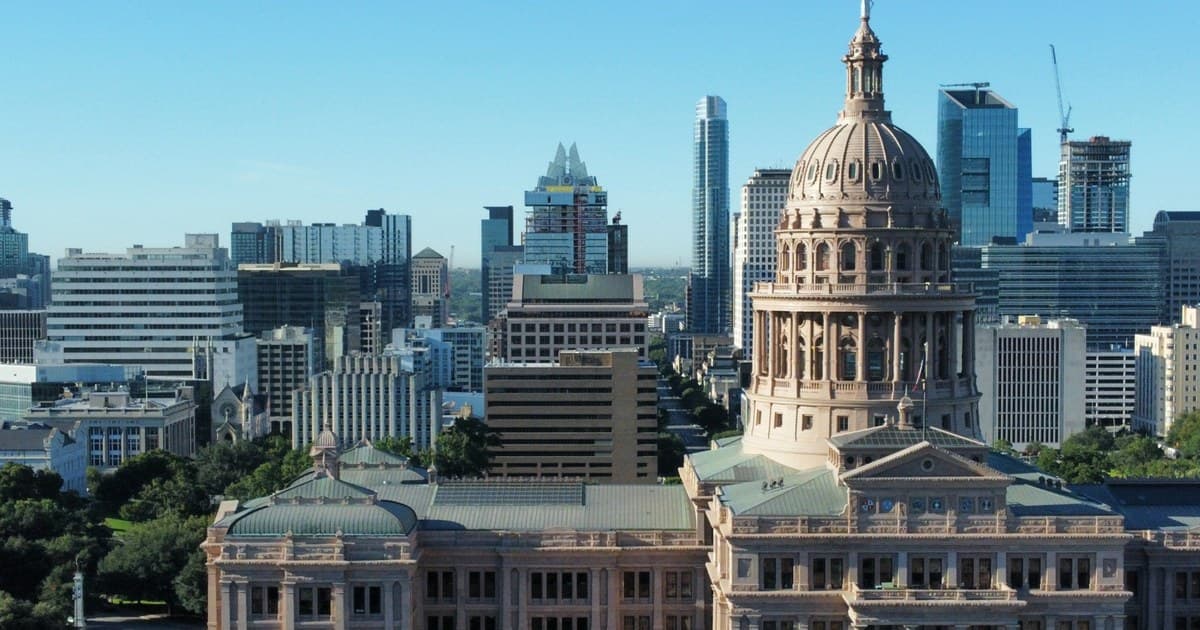 The Texas State Capitol dome in Austin, with the city skyline rising behind it