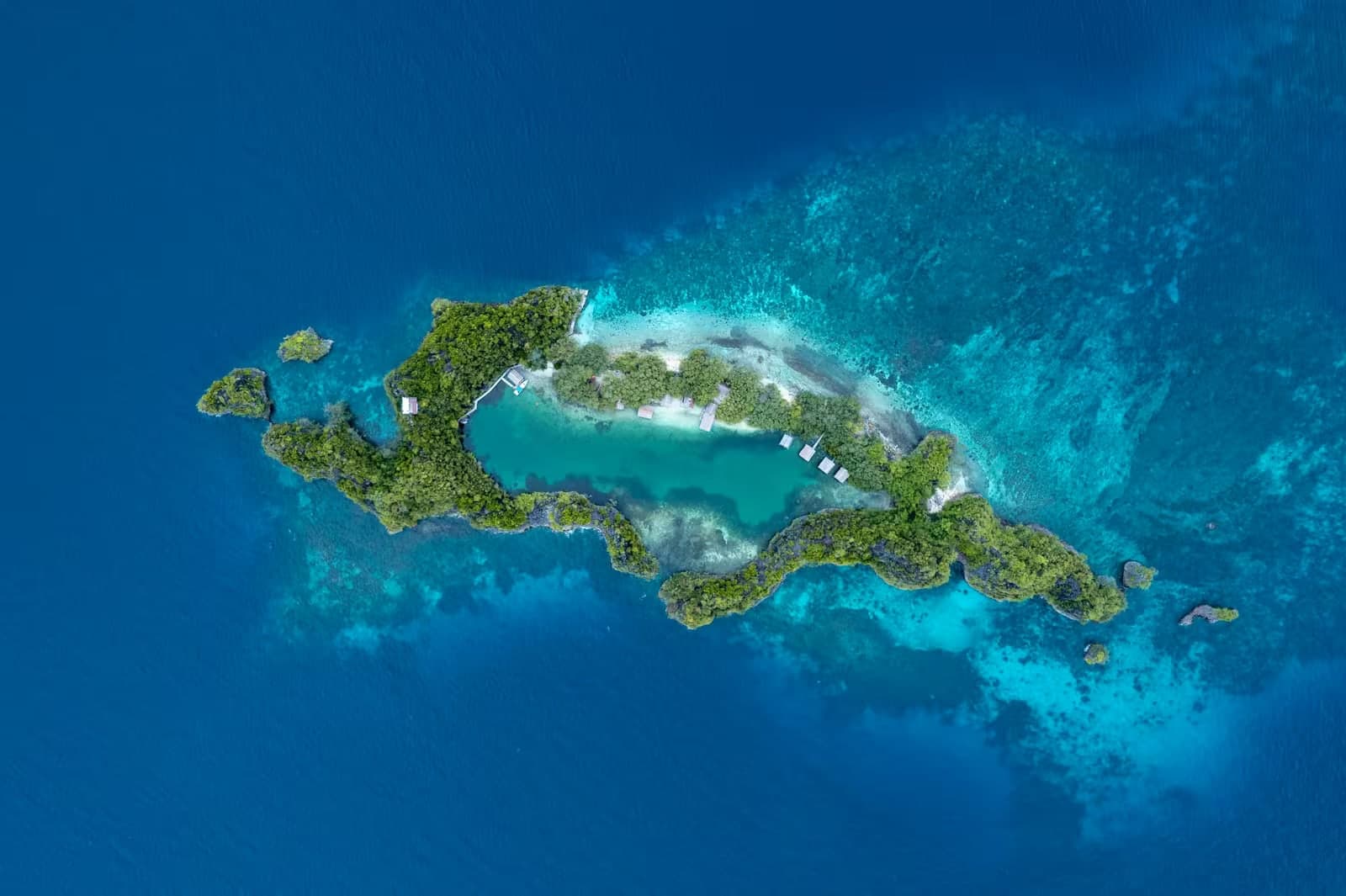 Aerial view of a Cook Islands reef atoll ringed by open ocean - the offshore jurisdiction behind foreign asset protection trusts