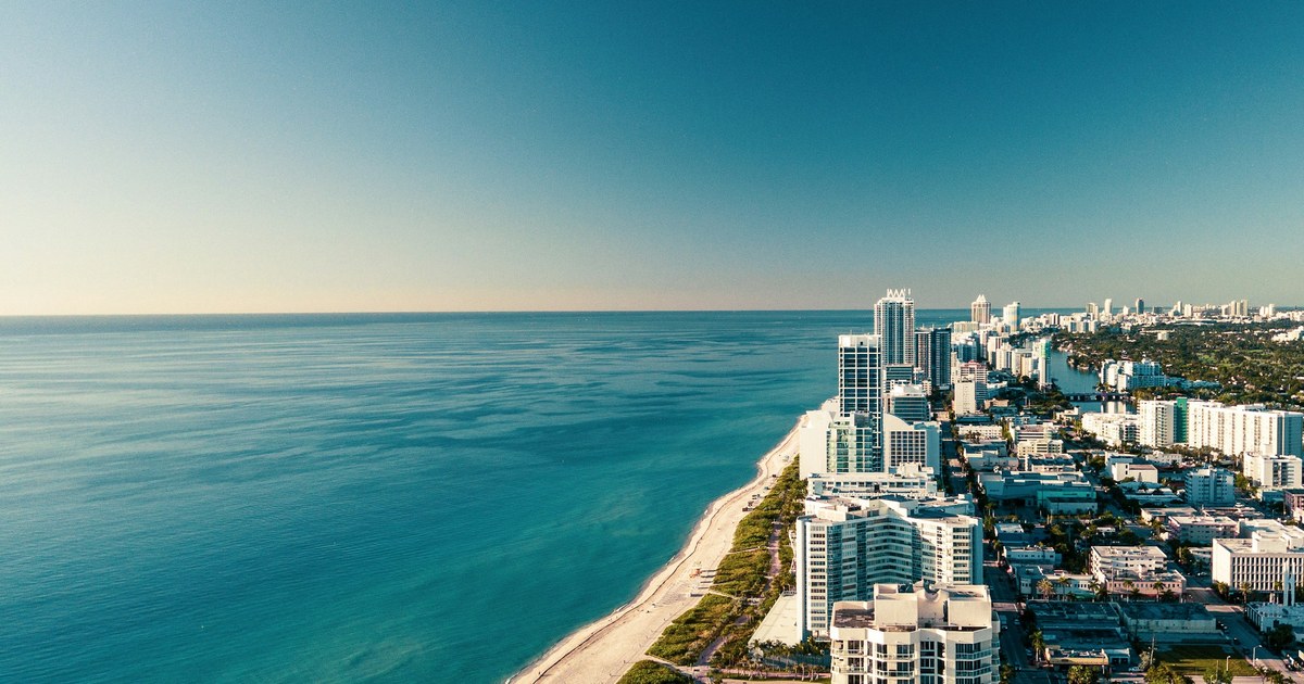 Aerial view of the Miami Beach coastline, with residential towers along the shore