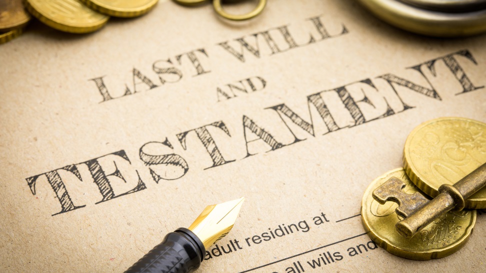 last will and testament document with pen and coins