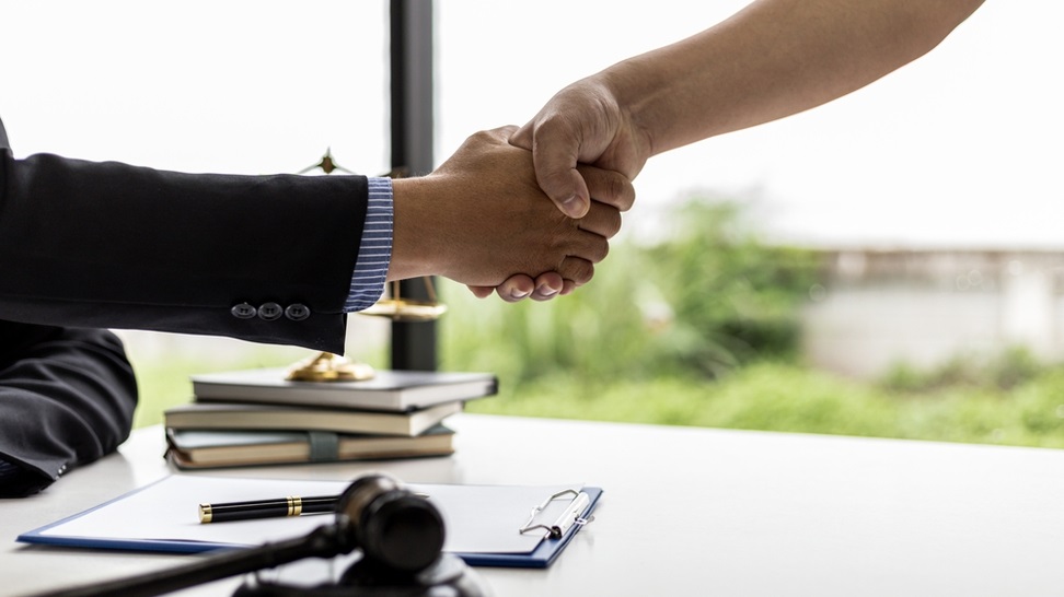 lawyer and a client handshake