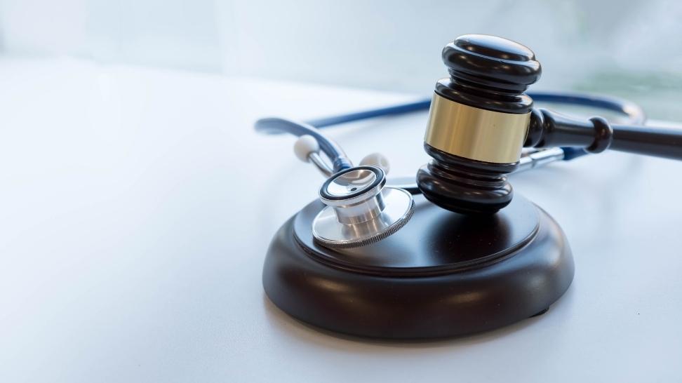 gavel and a stethoscope on a table