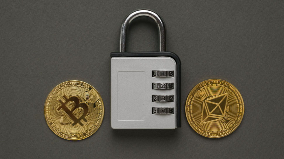 two digital coins and combination lock on dark gray background
