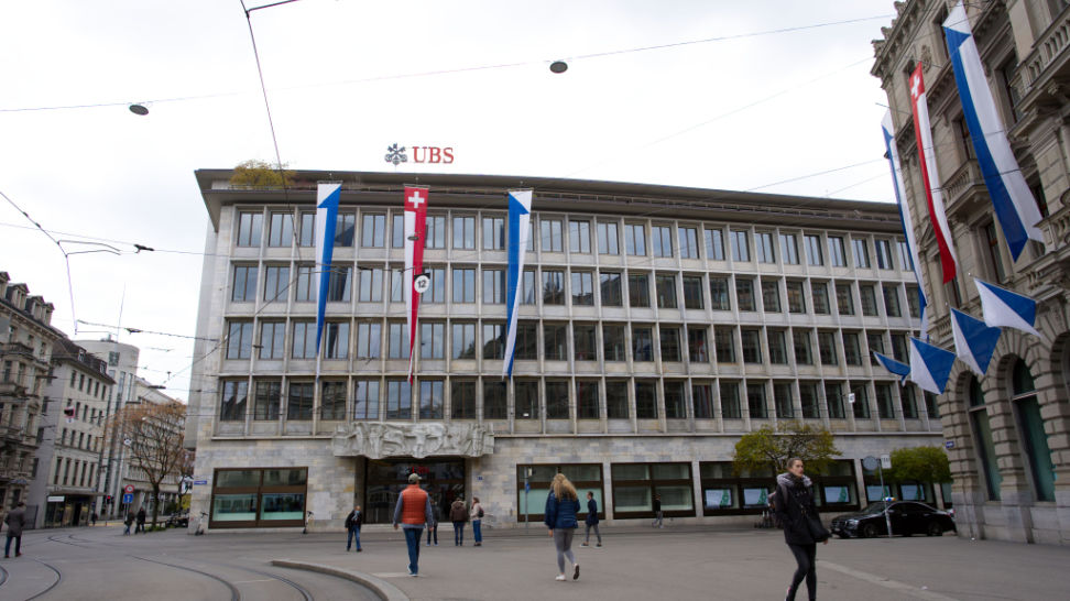 entrance of historic swiss bank ubs with swiss flag and canton of zurich
