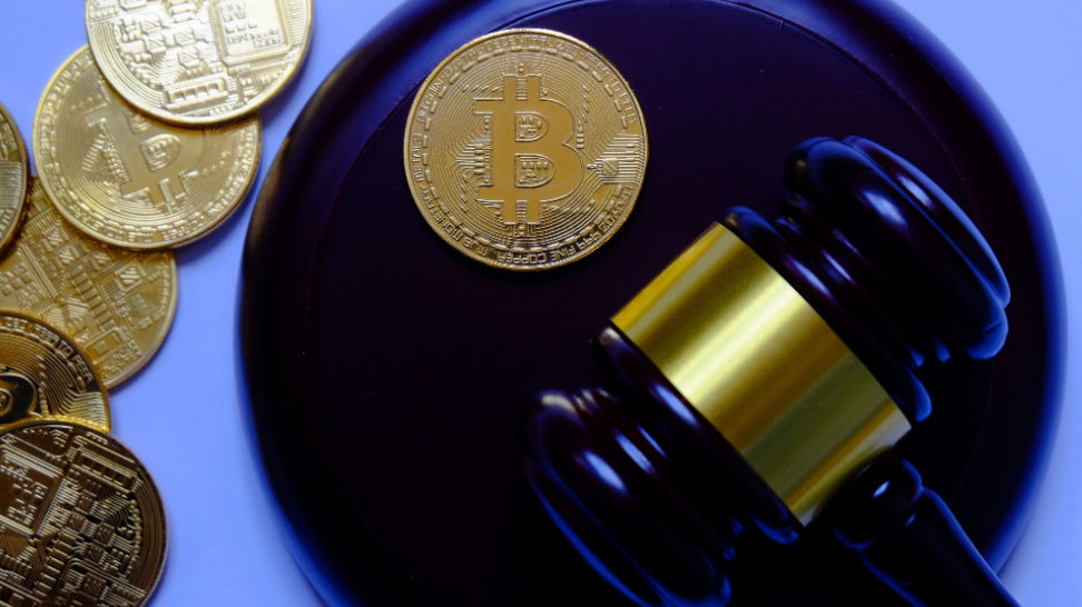 gavel and replica of gold bitcoins