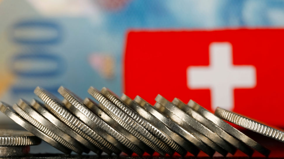 swiss coins on a swiss flag and one hundred francs banknote background