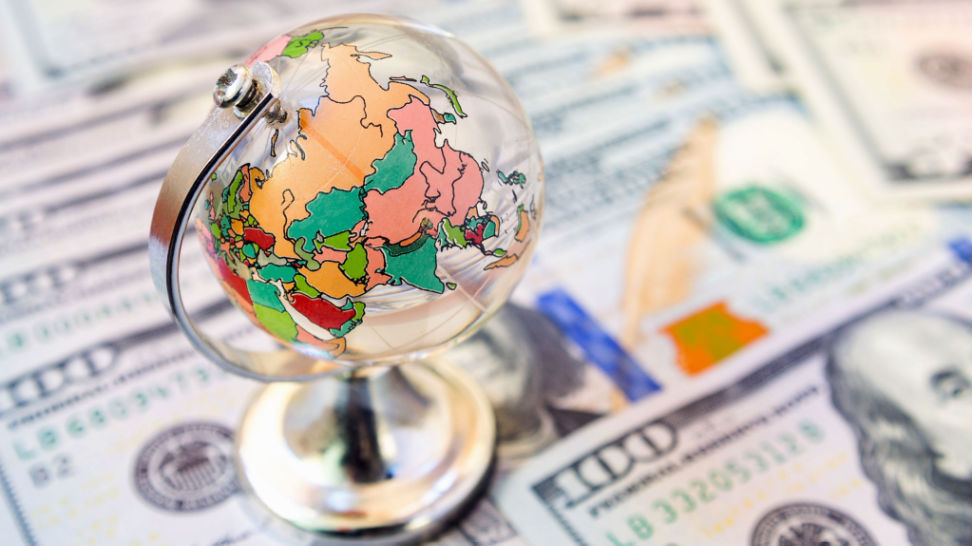 glass world globe on us dollars background