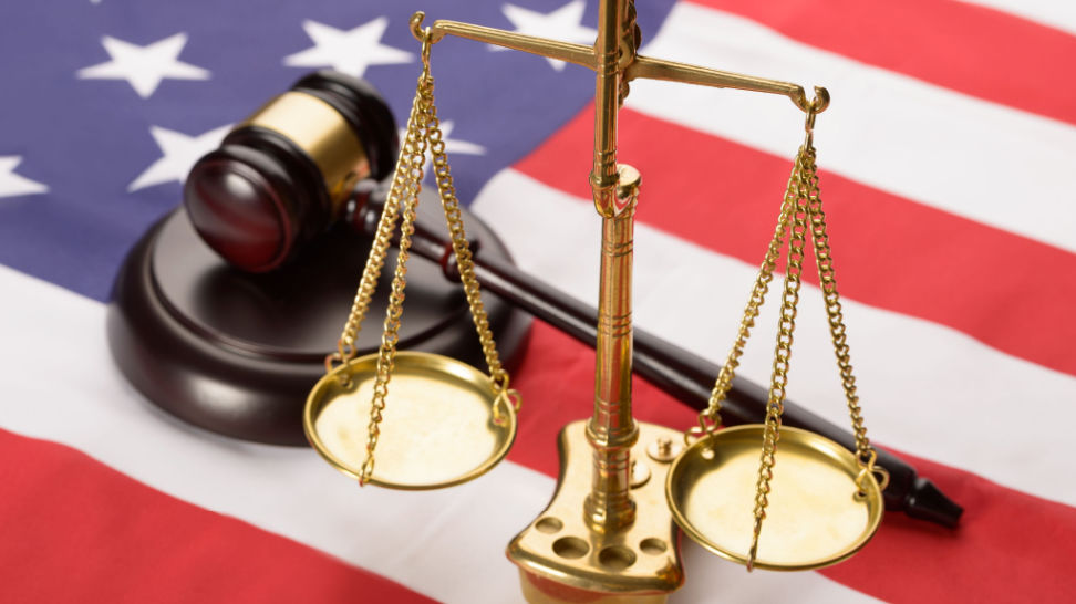 scale of justice and wooden gavel on usa flag