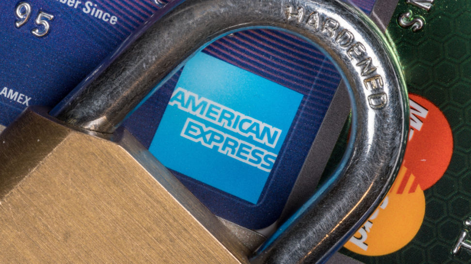 credit cards with brass lock and focus on american express symbol