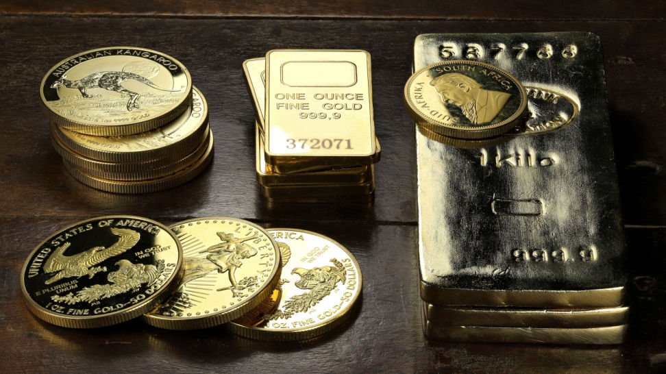 gold bars and gold coins on table