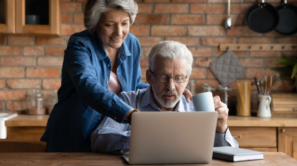 senior married couple researching which is better for real estate assets