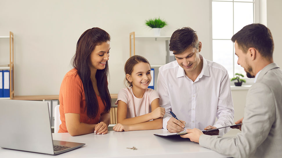 happy family signing documents for life insurance