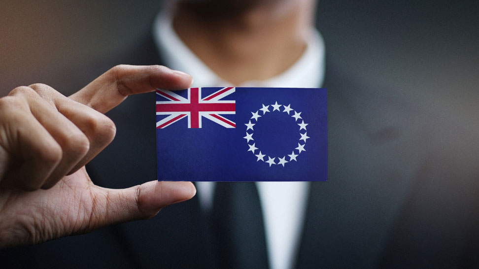 asset protection attorney holding card with cook island flag