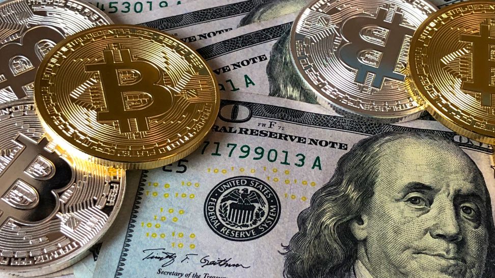 silver and gold bitcoin in us dollar banknotes