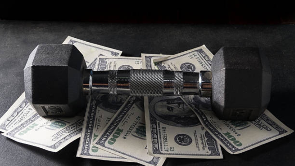 a dumbbell on top of money