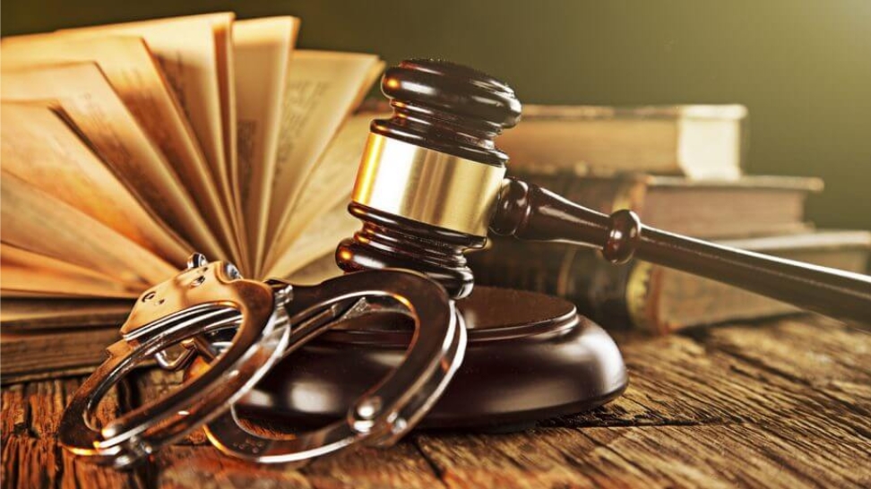 a gavel and handcuff on a table