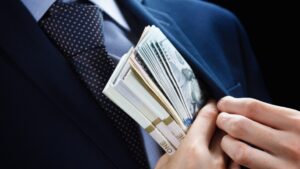 a man putting money in his pocket