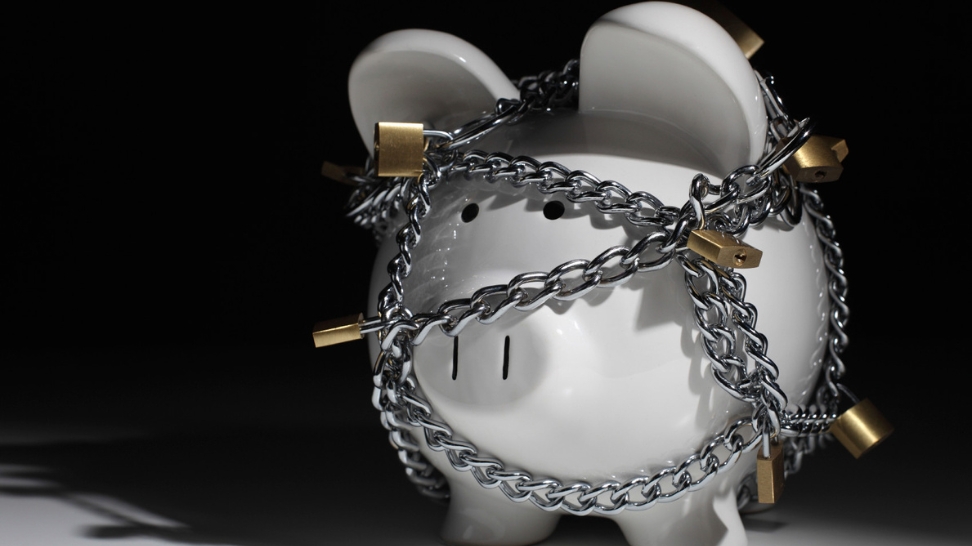 a piggy bank with chains and padlocks 