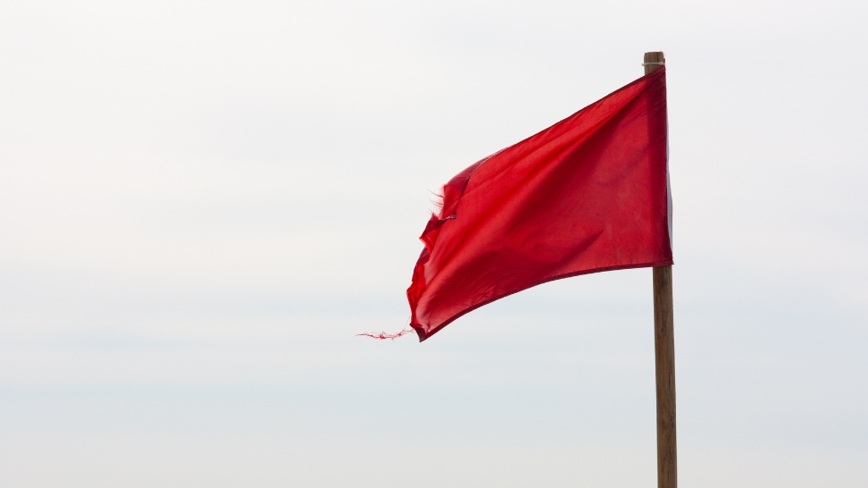 a red flag on a pole