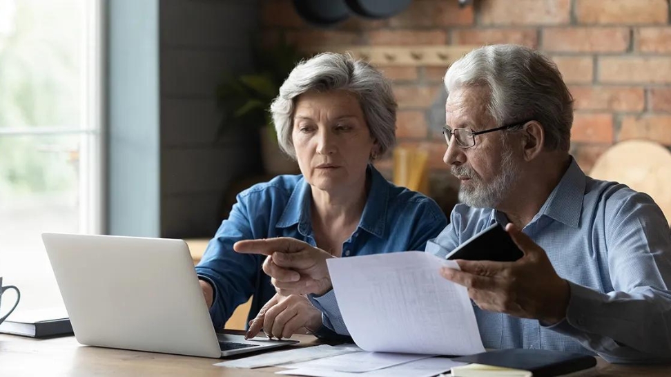 elderly couple discussing drawbacks of an irrevocable life insurance trust