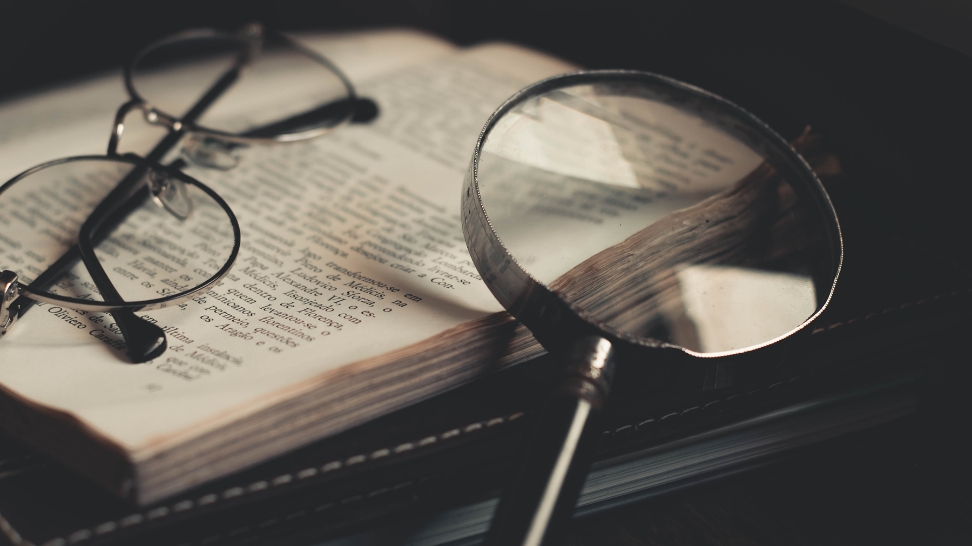 magnifying glass with book and eyeglasses