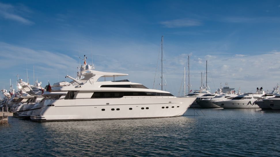 white luxury yachts in shipyard