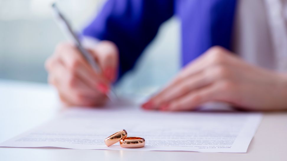 woman signing a prenup agreement