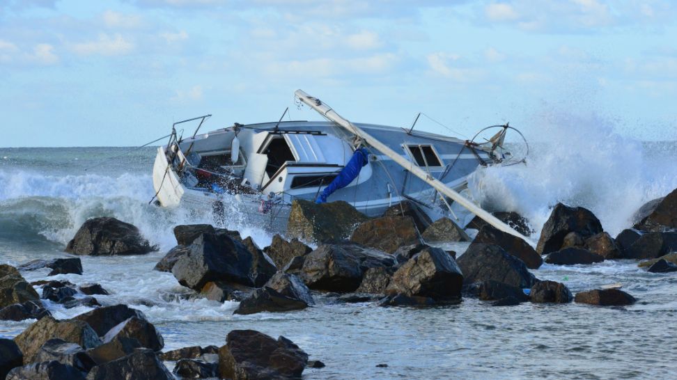 yacht shipwrecked on beach side