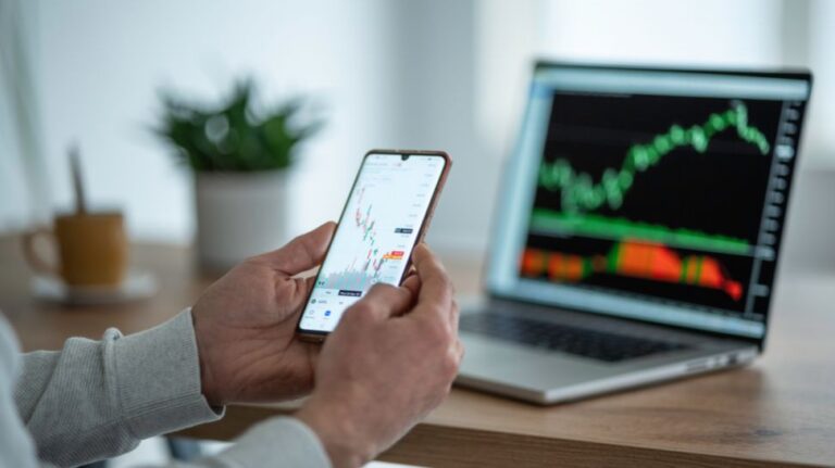 trader studying stock markets on mobile phone