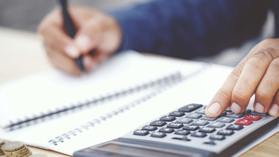 accountant calculating taxes using calculator