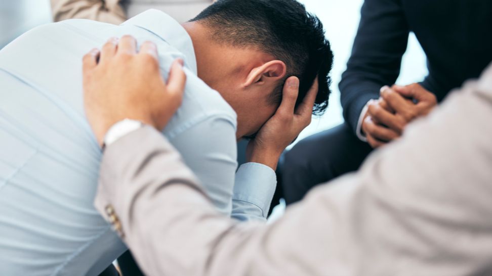 attorney trying to help male client suffering mental strain