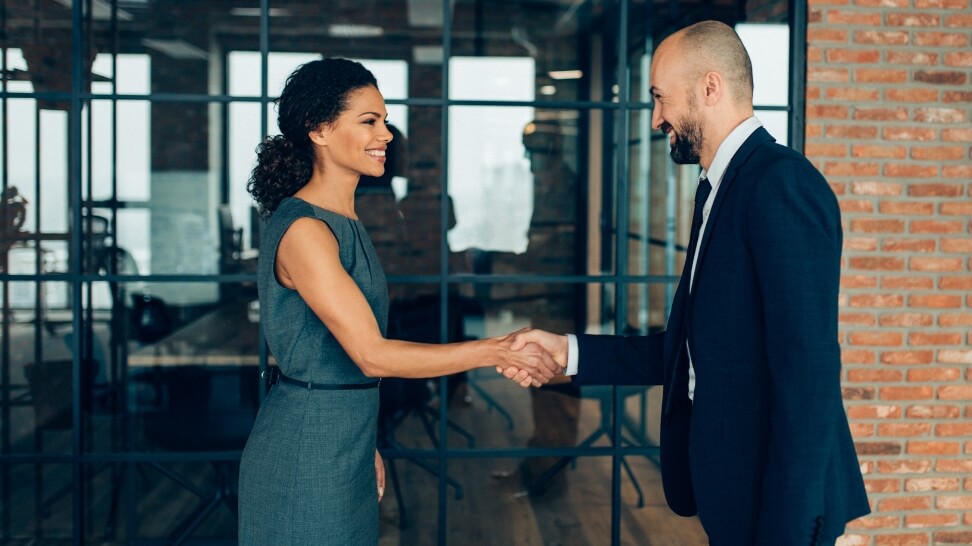 client shaking hands with attorney