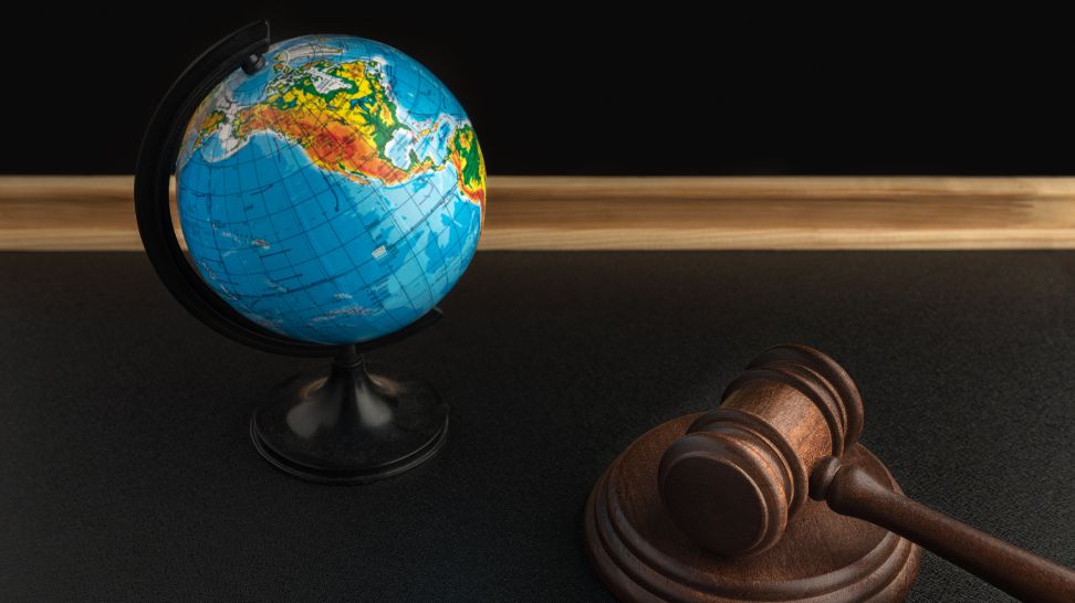 globe and gavel on dark background