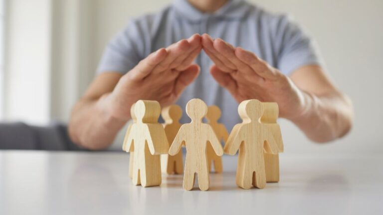 man covering wooden human figures