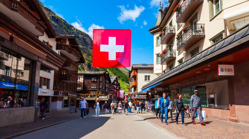 traditional houses with Switzerland flag hanging on ropes in between