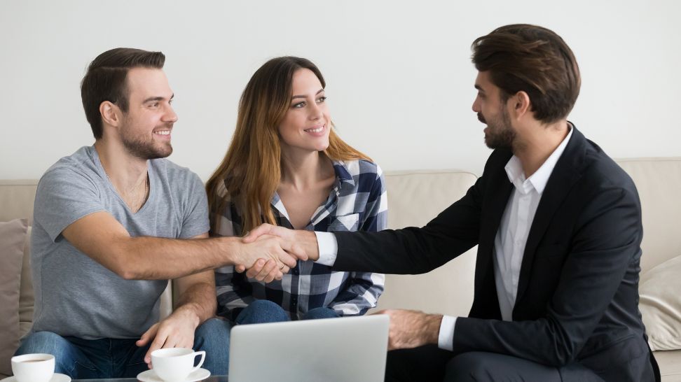 couple client handshaking real estate agent