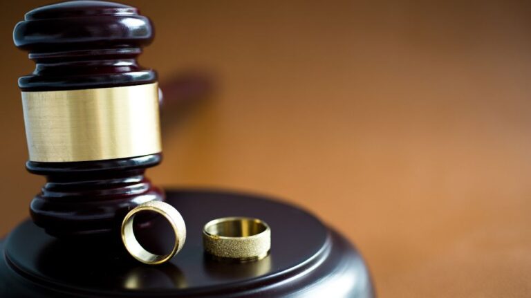 gold wedding ring in judge gavel