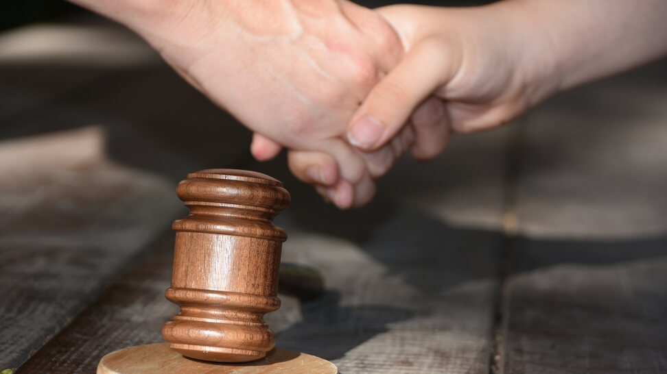 shaking hands with gavel underneath