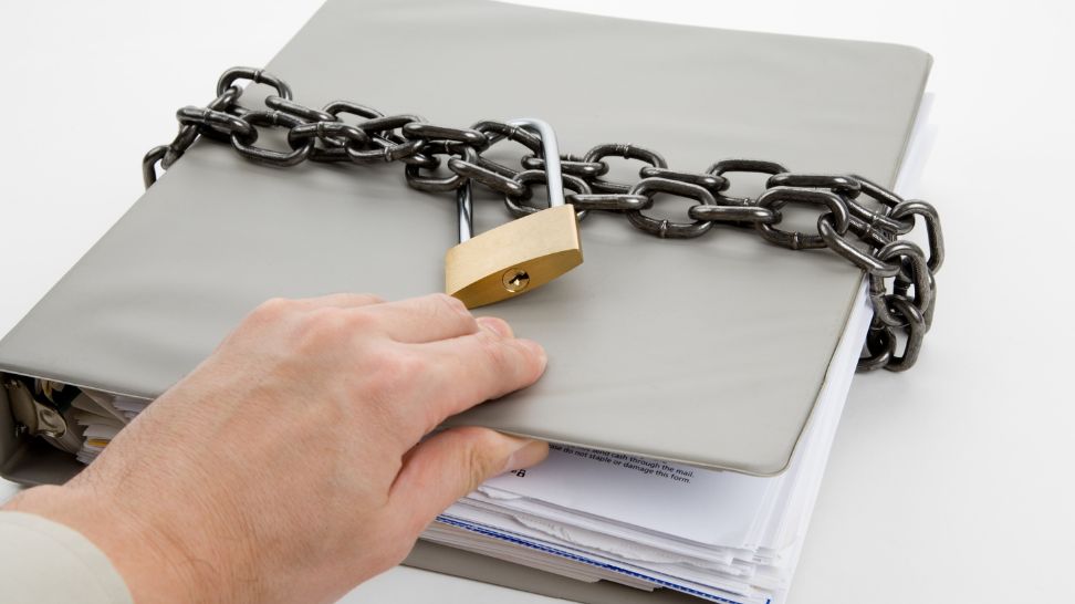 woman opening document with chain and padlock