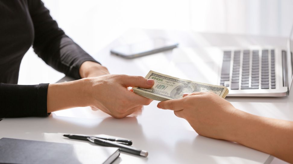 woman pulling cash asset from bank