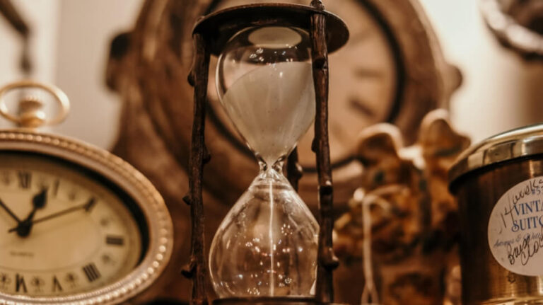 sand clock surrounded by different clocks