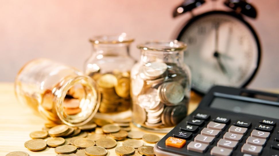 calculator coins in jar and clock