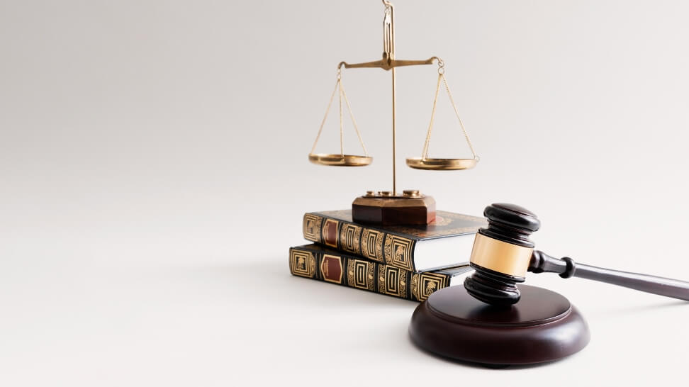 law books with weighing scale above it