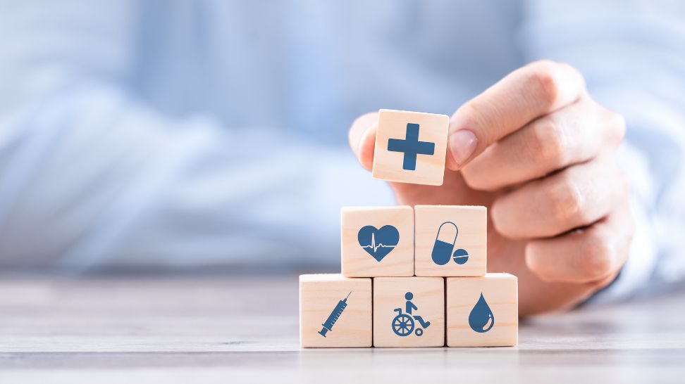 man stacking blocks with different icons