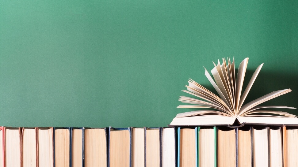 open book on top of book shelf