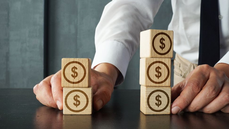 stack of wooden cubes with dollar sign