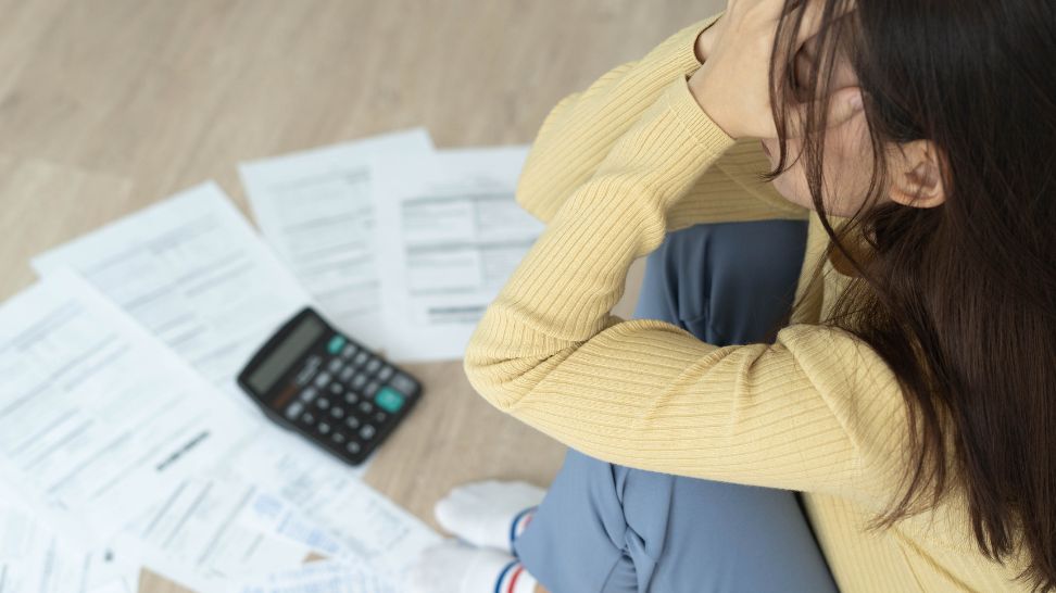 woman stressed with bills documents papers