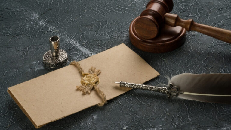 feather pen gavel and folded letter