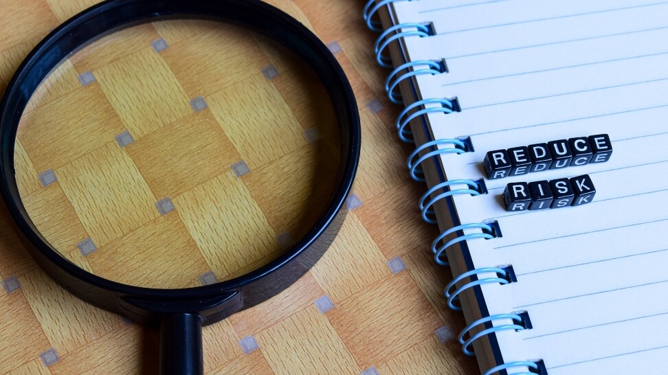 magnifying glass and a notebook